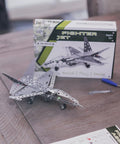Build Your Own Fighter Jet Erector Set Metal Model Airplane Kit with box and tools on wooden table