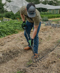 Person using Rugged Heavy Duty Digging Fork With Carbon Steel Head And Fiberglass Core, Short Handle With No-Slip H-Grip in garden
