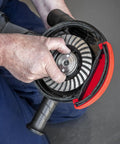 Adjustable Angle Grinder Dust Shroud With Swivel Hose Hookup And Slick Edge Guard fits 115 to 125 mm tools, shown being assembled.