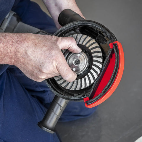 Adjustable Angle Grinder Dust Shroud With Swivel Hose Hookup And Slick Edge Guard fits 115 to 125 mm tools, shown being assembled.