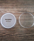 53.5mm Espresso Puck Screen Reusable 1.7mm Thick 100 Micron Stainless Steel Filter Mesh Plate with cover, on wood surface