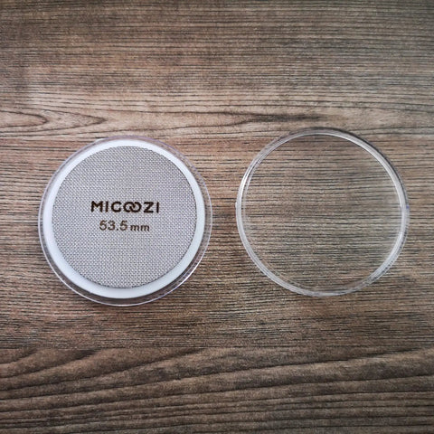 53.5mm Espresso Puck Screen Reusable 1.7mm Thick 100 Micron Stainless Steel Filter Mesh Plate with cover, on wood surface