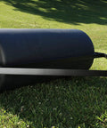 18-Inch by 36-Inch tow behind lawn roller in use on grass, heavy duty poly roller with 40 gallon capacity, side molded spokes visible