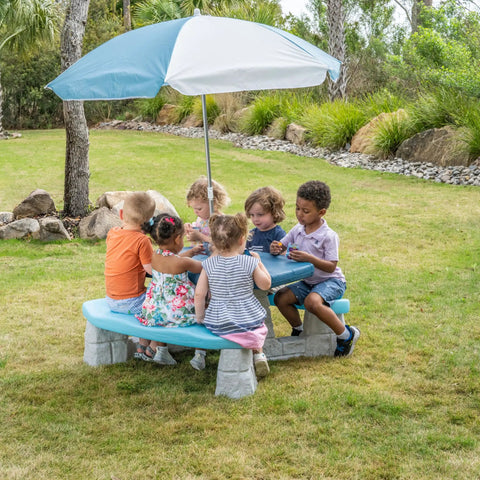 Kids playing at Sun And Fun Picnic Table With Umbrella For Indoor And Outdoor Use Toddler Sized Table With Five Foot Shade Canopy