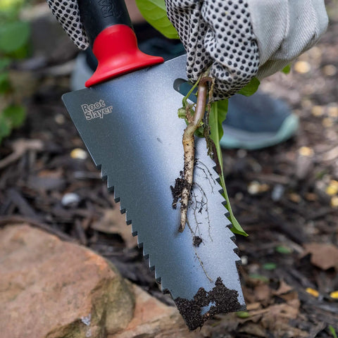 Gardener using All In One Garden Trowel With Holster For Digging Planting And Root Cutting Serrated Steel Blade Red Durable Comfortable Grip in soil.
