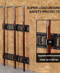 Close-up of wood-handled tools in heavy-duty E-track tool holders, showcasing load-bearing capacity for enclosed trailers.