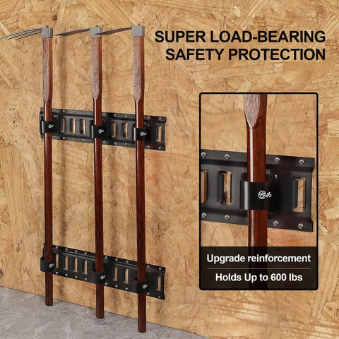 Close-up of wood-handled tools in heavy-duty E-track tool holders, showcasing load-bearing capacity for enclosed trailers.