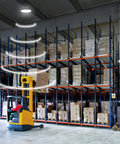 Heavy Duty 200W Led High Bay Shop Light With Motion Sensor illuminating a warehouse with shelves of boxes.