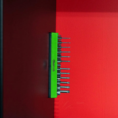 Magnetic Hex Bit Organizer Tray With Green Base Holds 37 One Quarter Inch Bits Drill Bit Storage attached to steel surface.