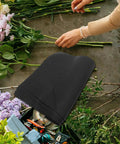 10 Piece Floral Embossed Kraft Paper Sheets with polka dot texture for bouquet wrapping, surrounded by flowers and tools.