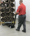Massive 10K Lb Electric Industrial Tugger With Heavy Duty Steel Build Perfect for Moving Big Rig Vehicles moves rolls of material.