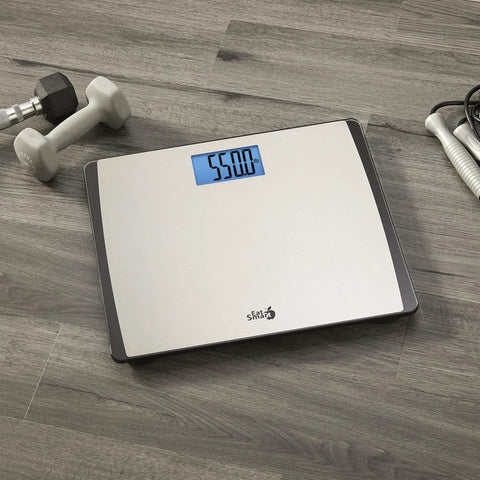 Digital Bathroom Scale 550 Pound Capacity With Extra Wide 15 Inch By 13 Inch Platform Stainless Steel Body on wood floor