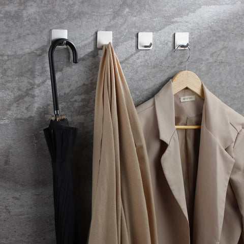 Self Adhesive Towel Hooks Four Pack Stick On Wall Stainless Steel 304 No Drill Bathroom Kitchen Hooks For Keys Robes And Towels Holds Up To 21 Pounds Heavy Duty Adhesive holding umbrella, towel, and coat on stone wall