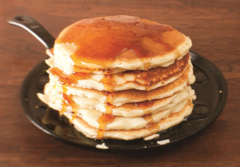 Round Cast Iron Griddle Pan 10.5 Inch Pre Seasoned Non Toxic PFAS Free Cookware with pancakes topped with syrup