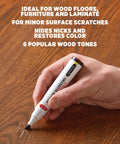 Slick No Fuss Scratch Repair Marker For Hardwood Floors And Furniture Hide Deep Nicks Scrapes On Cabinets Laminate Door Trim Restore That Like New Look With Simple Glide Application Total Weekend Warrior Pick, hand using marker on wood.