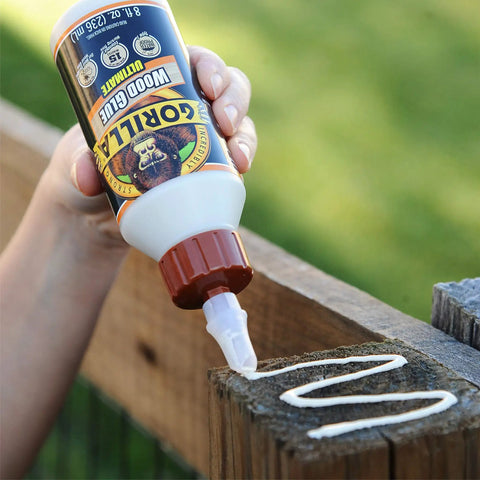 Hand applying Ultimate Waterproof Wood Glue For Indoor And Outdoor Projects In Natural Wood Color, 8 Oz Pack Of 2 on wood