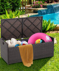 Outdoor 34 Gallon Storage Bench With Seat Cushion And Waterproof Liner, Wicker Brown Deck Box With Side Handles by the pool