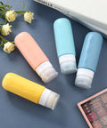 Leak Proof TSA Approved Travel Bottles Set For Toiletries Refillable Containers For Shampoo Lotion Soap And Cosmetics Grab N Go BPA Free Leak Proof Travel Essentials Compact Size For Easy Packing, displayed in pastel colors on blue surface