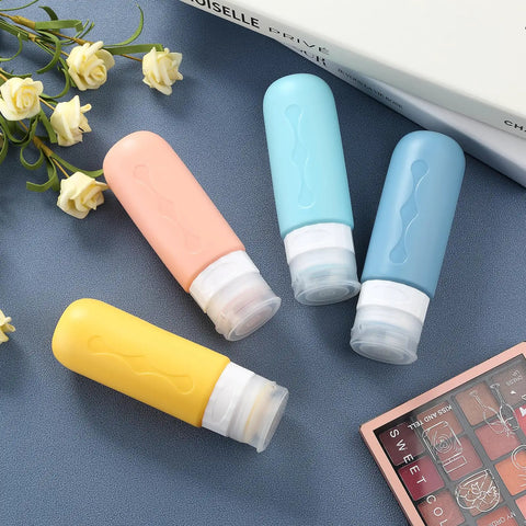 Leak Proof TSA Approved Travel Bottles Set For Toiletries Refillable Containers For Shampoo Lotion Soap And Cosmetics Grab N Go BPA Free Leak Proof Travel Essentials Compact Size For Easy Packing, displayed in pastel colors on blue surface