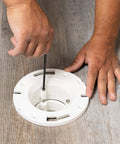 Installing the Four Inch Closet Flange Replacement For Toilets With Adjustable Compression Joint on floor surface