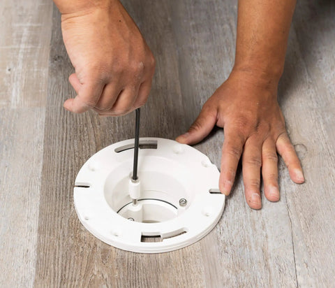 Installing the Four Inch Closet Flange Replacement For Toilets With Adjustable Compression Joint on floor surface