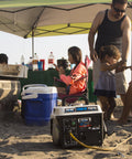 Portable Gas Powered Generator With Carrying Handle 1200W Peak 900W Running in use at a beach picnic setting