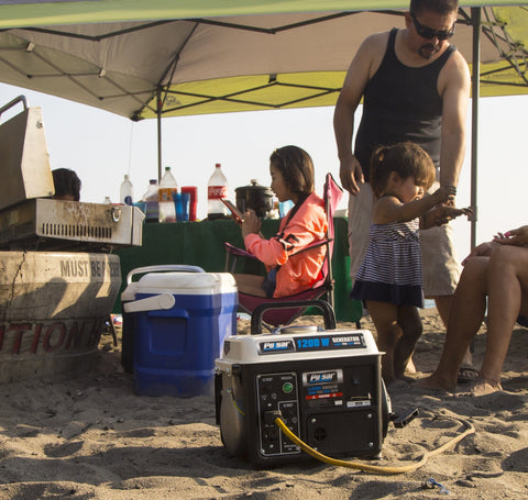 Portable Gas Powered Generator With Carrying Handle 1200W Peak 900W Running in use at a beach picnic setting