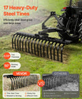 50 Inch Tow Behind Landscape Rake With 17 Steel Tines For Category 1 Tractors clearing grass with angle adjustment.