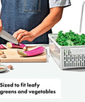 Person chopping vegetables near Produce Saver Bin With Adjustable Divider For Fresh Produce Storage In Fridge Medium White BPA Free