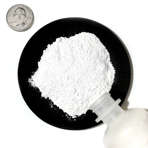 Calcium Phosphate Tribasic Fine Powder 4 Oz Bottle, 99.9% Pure ACS Reagent Grade, close-up of white powder with coin for scale.