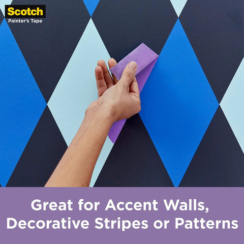 Hand applying Delicate Surface Painter’s Tape for fresh paint jobs on patterned wall, 1.88 in wide, no adhesive transfer.