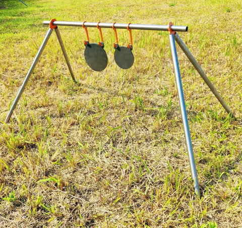 AR500 Steel Target Gong Silhouette For Precision Shooting, Half Inch Thick, on a metal frame in grassy field