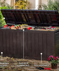 71 Gallon Outdoor Resin Storage Box For Patio Cushions And Throw Pillows, open lid, filled with tools, garden setting