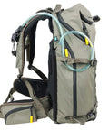 Side view of khaki green Active 53 Camera Backpack with front rear and top access, built-in USB charger port, removable camera box insert.