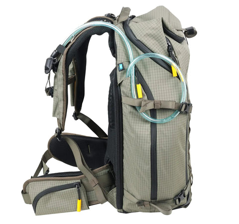 Side view of khaki green Active 53 Camera Backpack with front rear and top access, built-in USB charger port, removable camera box insert.