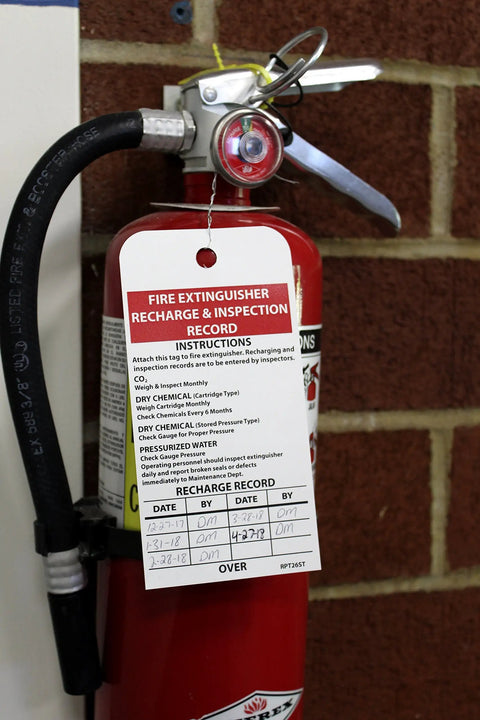 Fire Extinguisher Recharge and Inspection Tag Made on Synthetic Paper Polytag White for Easy Compliance attached to extinguisher