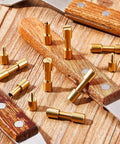Beefy Brass Bolt Fasteners Set, 20 Pieces, 6 mm Head Diameter Blind Rivets For Knife Making And EDC Handle Pins displayed on wood.