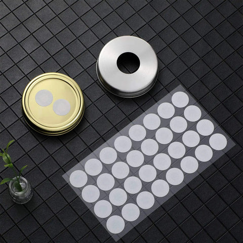 Sheet of 128 Pieces Synthetic Filter Paper Discs for Mushroom Cultivation, 20 mm Diameter, shown with wide mouth jar lids.
