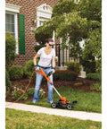 Person using 3-In-1 Electric Lawn Mower, Trimmer And Edger With 6.5 Amp Motor, 12 Inch Cutting Width, Corded Power For Quick Yard Cleanup