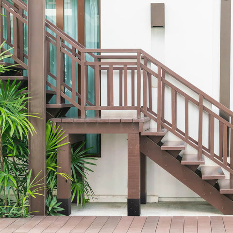 Outdoor wooden stairs secured with 4x4 Post Anchor Ground Spike Kit For Concrete Decks, Beefed-Up Steel With Black Powder Coat, Fits 3.5x3.5 Inch Wood Posts, Post Base Holder Brackets, Weatherproof Outdoor Use, 4 Pack.