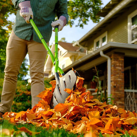 Person using Gator Grabber Telescoping Leaf Cleanup Tool with adjustable handle, powder-coated steel shafts, and poly fiber jaws on leaves.