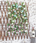 Expandable Wood Trellis For Outdoor Walls, Lattice Garden Panel adorned with roses, mounted on a brick wall, decorative garden accent