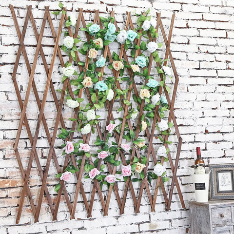 Expandable Wood Trellis For Outdoor Walls, Lattice Garden Panel adorned with roses, mounted on a brick wall, decorative garden accent
