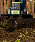 Corded Electric Garden Tiller Cultivator With 12.5 Amp Motor 16 Inch Tilling Width in action on soil close-up