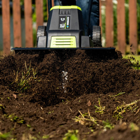 Corded Electric Garden Tiller Cultivator With 12.5 Amp Motor 16 Inch Tilling Width in action on soil close-up