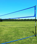 Heavy Duty Volleyball Net Set With Anti Sag System And Aluminum Poles Adjustable Height From Eight Feet To Seven Feet Eight Inches installed in a grassy field.