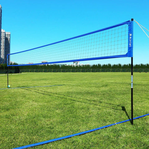 Heavy Duty Volleyball Net Set With Anti Sag System And Aluminum Poles Adjustable Height From Eight Feet To Seven Feet Eight Inches installed in a grassy field.