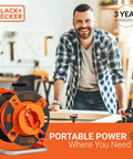 Man in workshop with 50 Ft Outdoor Extension Cord Reel With 14 AWG SJTW Cable, Heavy Duty Rewind Handle, Premium Cord Retractor.