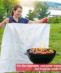 Woman using Extra Large 60 By 70 Inch Fiberglass Fire Blanket For Grills BBQs Campfires And Tailgating With Patent Pending Safety Handles.