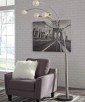 Modern floor lamp with crystal accents and arc design placed beside an armchair in a stylish living room setting.